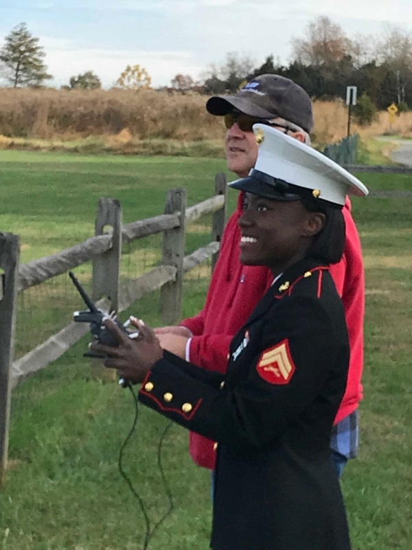 A Marine volunteer visits our annual Toys for Tots Fun Fly and tries her hand at radio control. She did great!